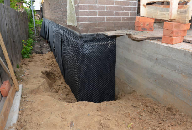 SJ Waterproofing Pros technician performing targeted Wet Basement Repair assessment in Straughn, IN